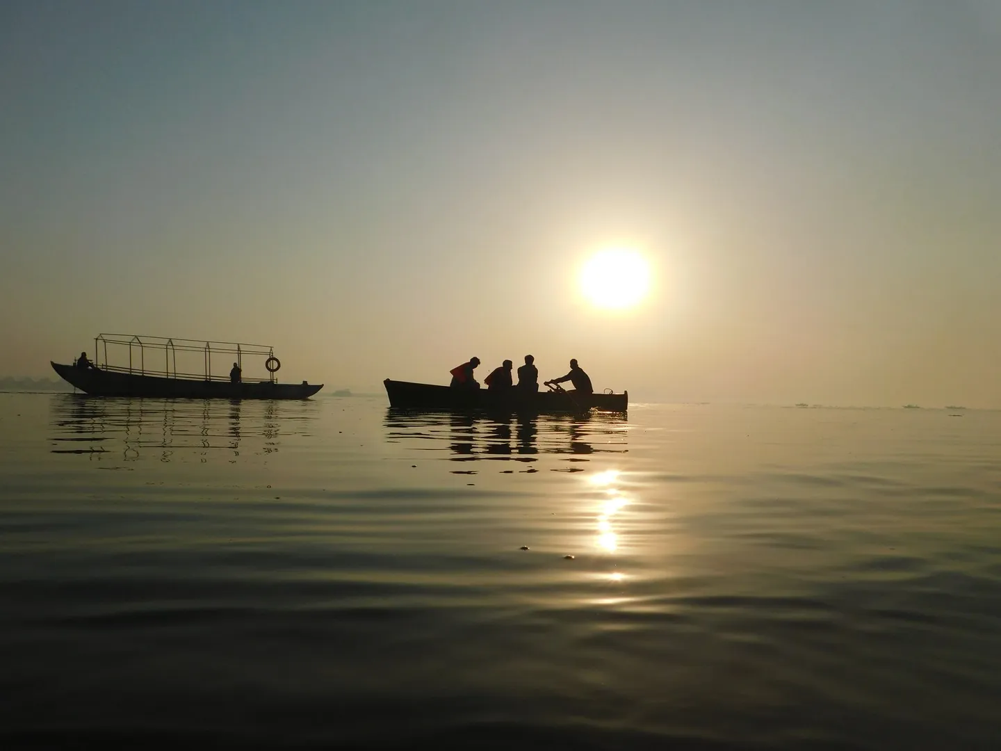 Boat in the Ganga with Rising Sun in background