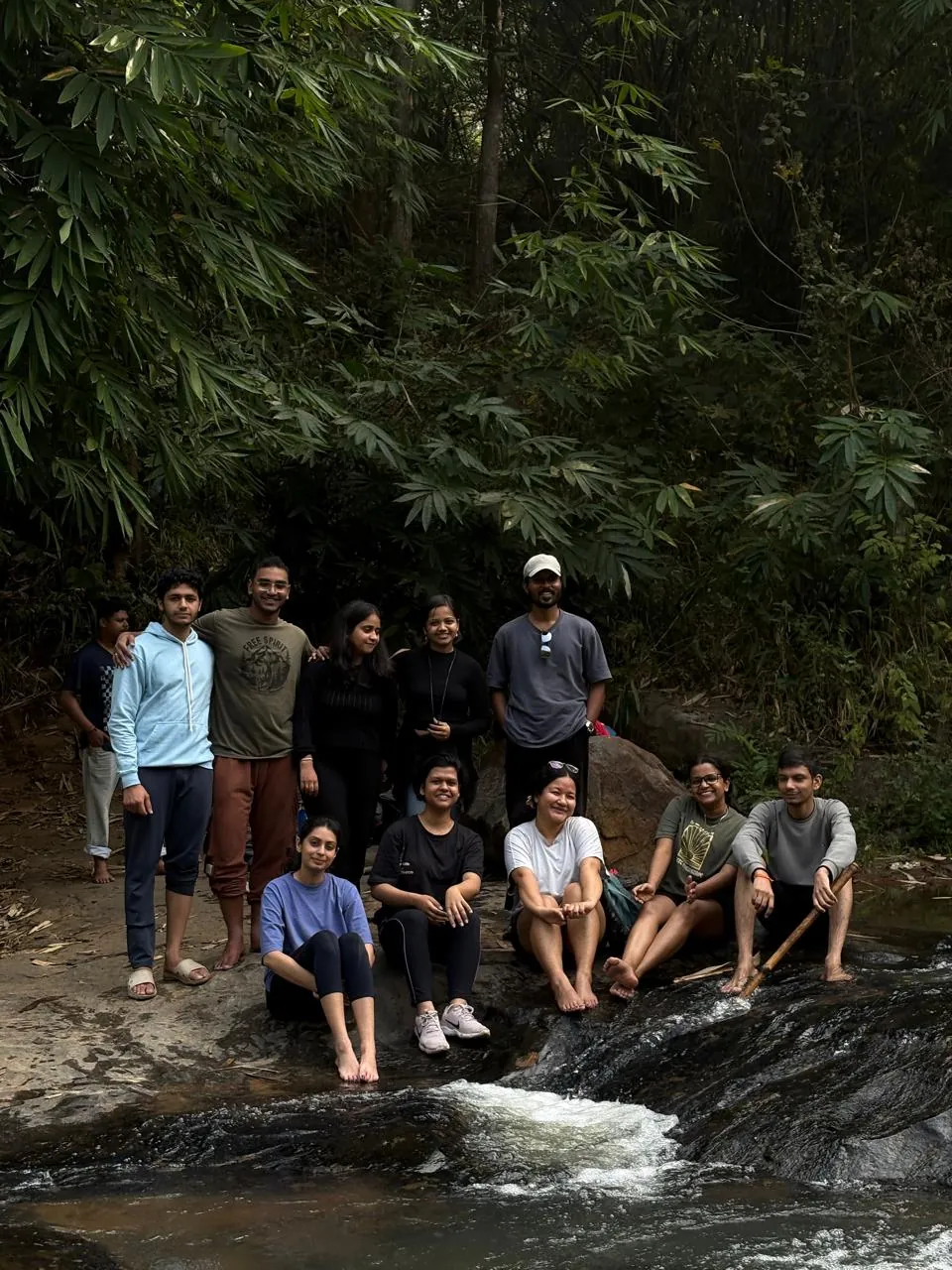Trekking Group sitting near waterfall